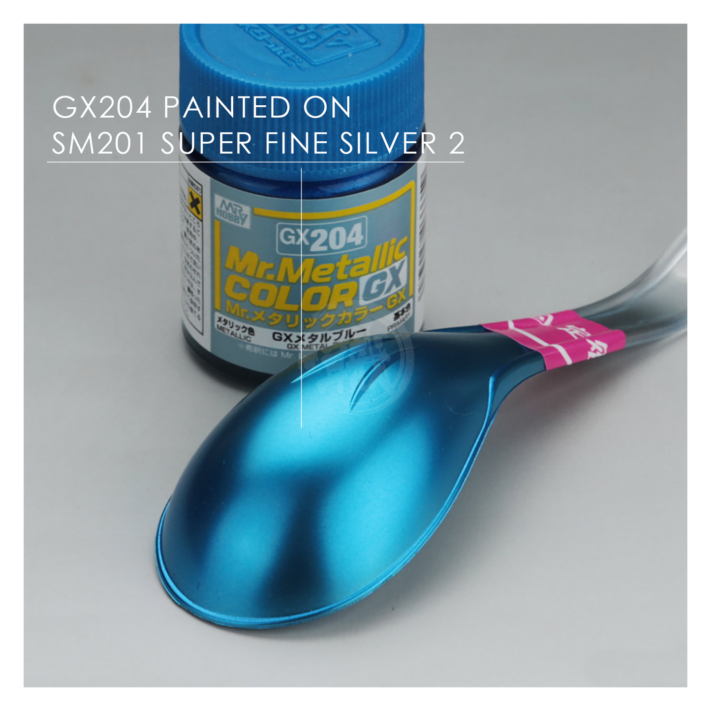 Blue metal paint in a GSI Creos GX204 bottle, showcasing vibrant metallic blue finish and smooth consistency.
