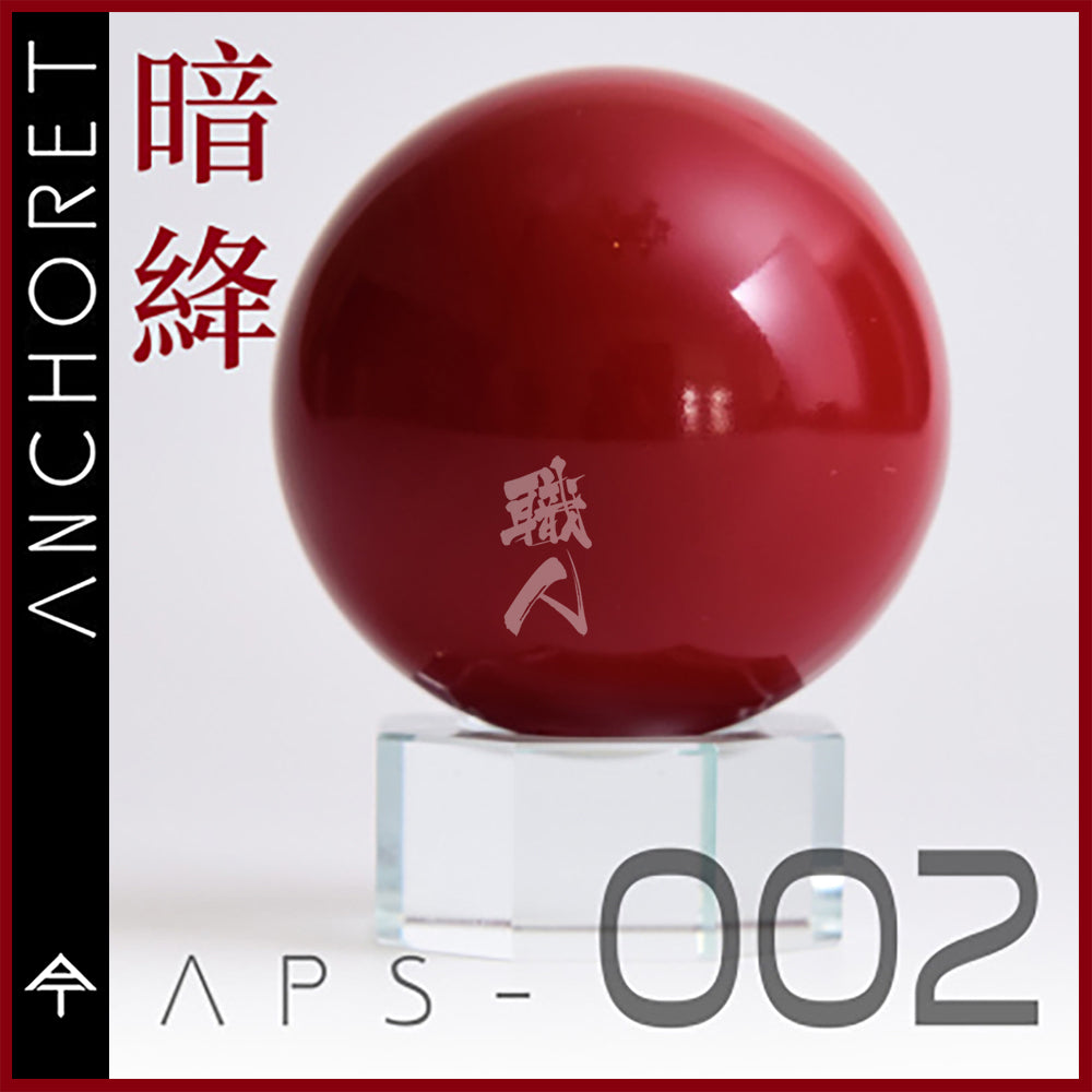 Dark red AnchoreT paint bottle labeled APS-002, with a close-up of the paint container and branding.